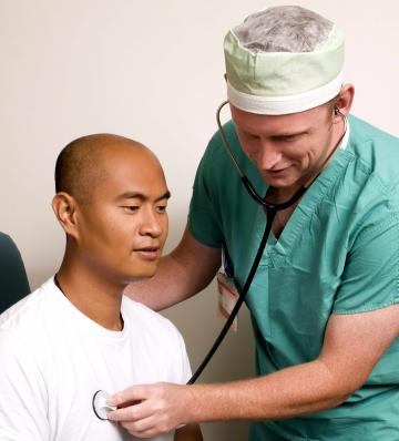 Doctor Examines Patient With Heart Palpitations