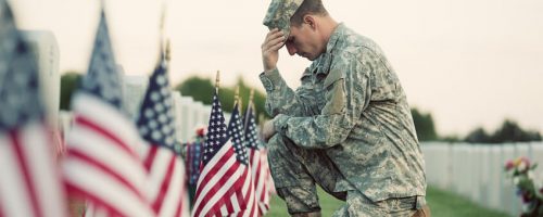 Serviceman honoring fallen soldiers