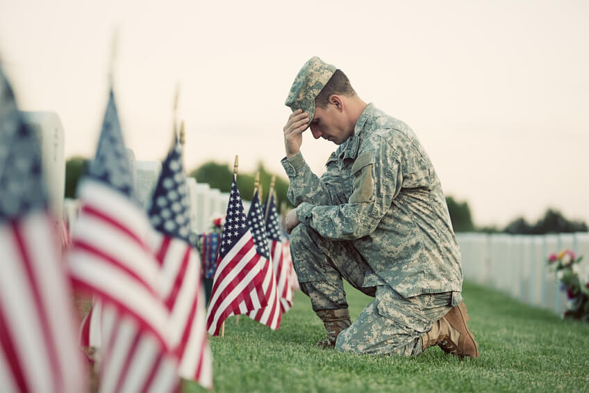 Serviceman honoring fallen soldiers