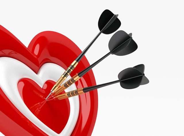 Darts on a heart shaped dart board