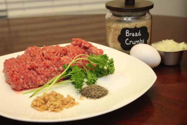 Raw meat and spices in preparation to make turkey burgers