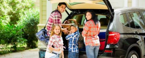 family packing a car for vacation