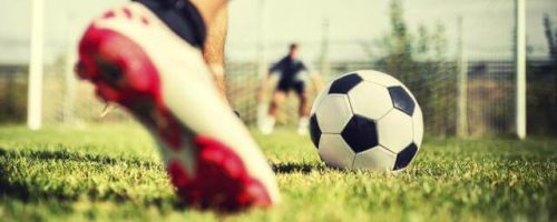 Teen Kicking Soccer Ball