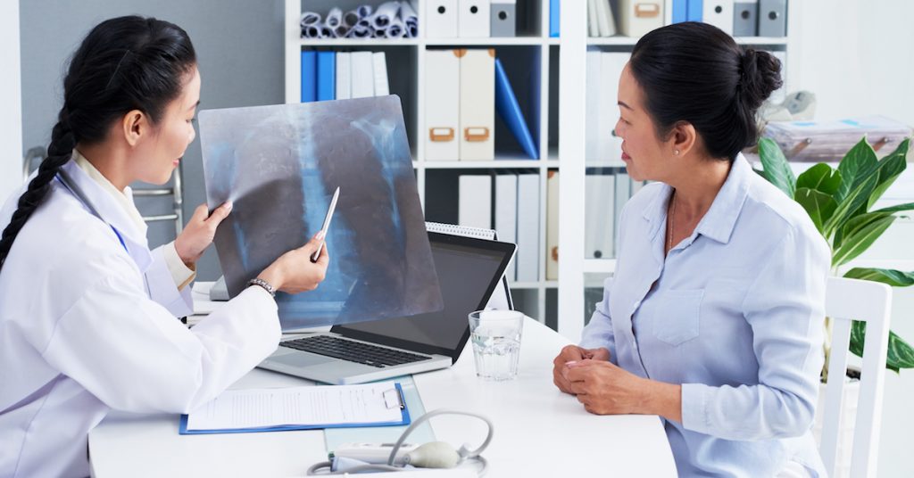 Doctor showing chest x-ray to patient