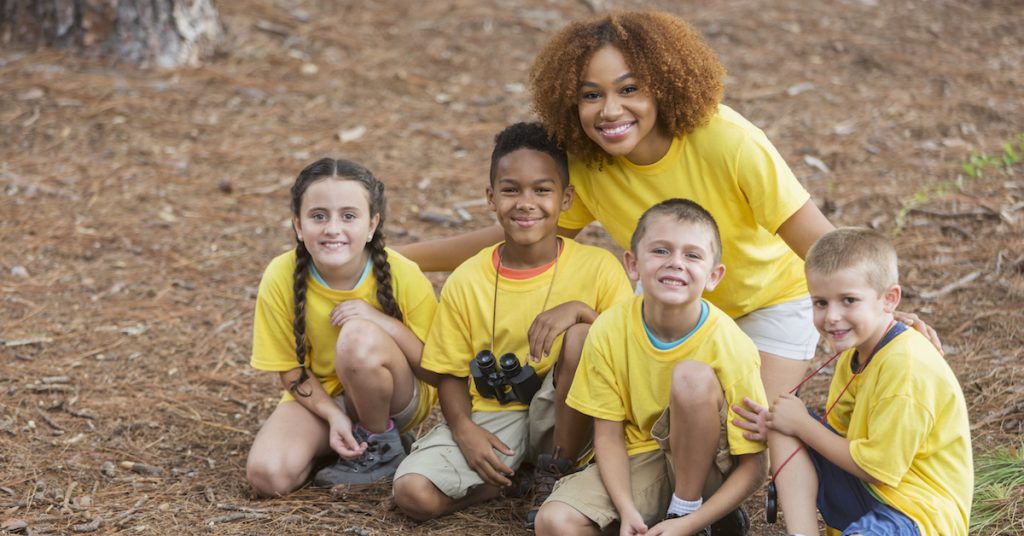 Picture of kids exploring nature at summer camp.