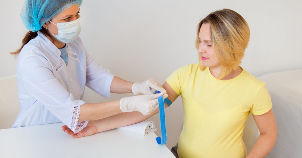 Picture of a doctor vaccinating a pregnant woman