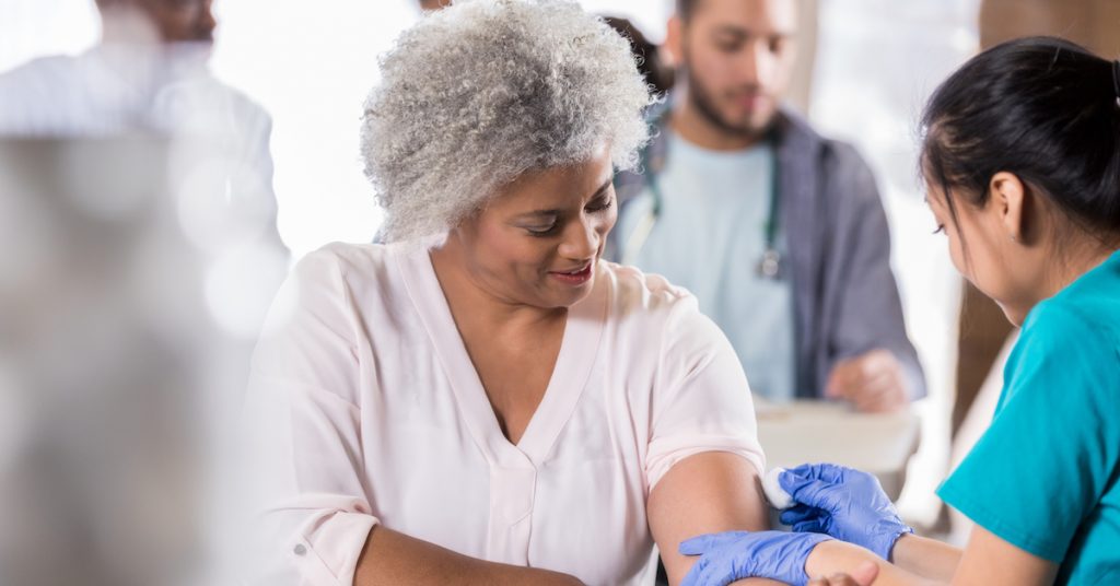 Picture of woman preparing to receive a flu shot