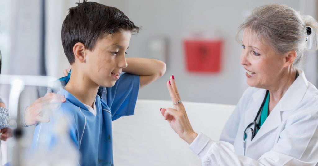 Picture of child being checked for concussion.