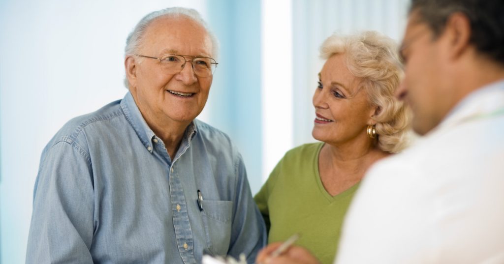 Picture of Senior couple talking with doctor.