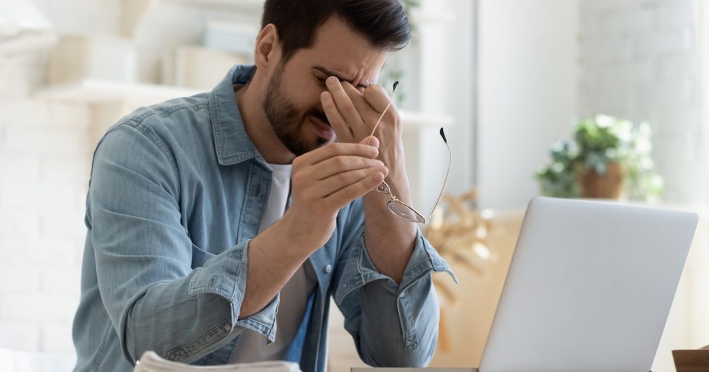 Image of man rubbing his eyes.