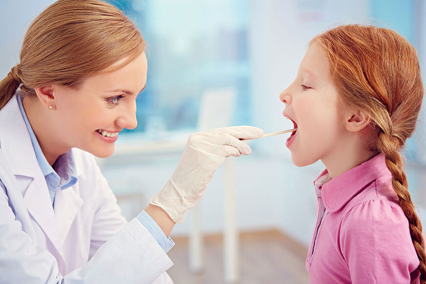 doctor checking girls throat